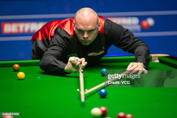 Stuart Bingham of England plays a shot during his first round match against Peter Ebdon of England on day two of Betfred World Championship 2017 at...