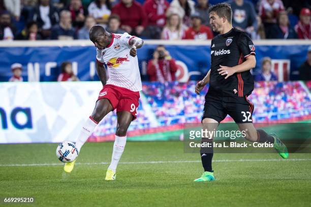 March 15: New York Red Bulls Forward Bradley Wright-Phillips moves past DC United Defender Bobby Boswell to take the shot on goal during the Soccer-...