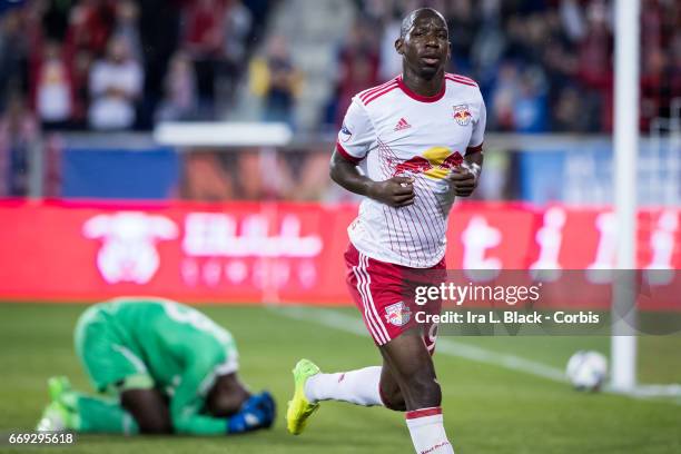 March 15: New York Red Bulls Forward Bradley Wright-Phillips begins to celebrate with DC United goalkeeper Bill Hamid on the ground in frustration...