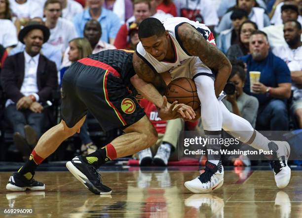 Washington Wizards guard Bradley Beal is fouled by Atlanta Hawks guard Jose Calderon as he tries to maintain control of the ball during the first...