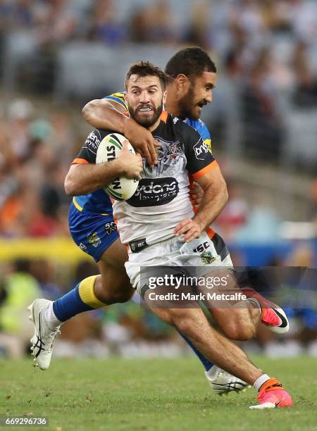 James Tedesco of the Tigers is tackled during the round seven NRL match between the Parramatta Eels and the Wests Tigers at ANZ Stadium on April 17,...