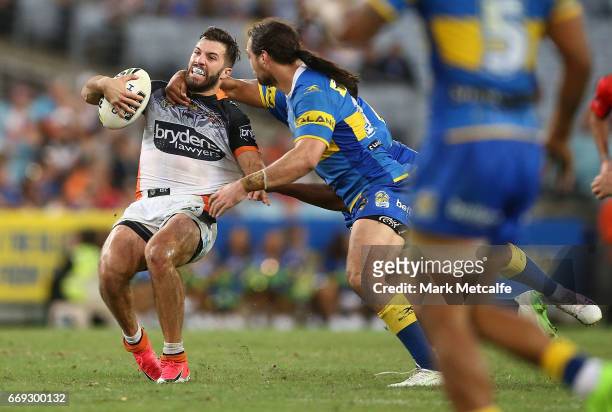 James Tedesco of the Tigers is tackled during the round seven NRL match between the Parramatta Eels and the Wests Tigers at ANZ Stadium on April 17,...