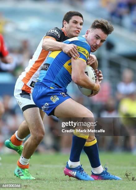 Clinton Gutherson of the Eels is tackled by Mitch Moses of the Tigers during the round seven NRL match between the Parramatta Eels and the Wests...