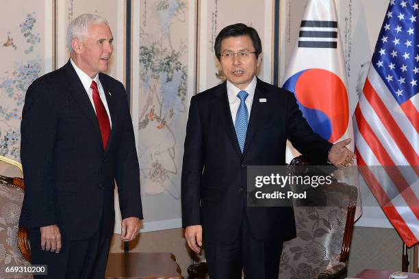 Vice President Mike Pence talks with South Korean acting president and prime minister Hwang Kyo-ahn during their meeting on April 17, 2017 in Seoul,...