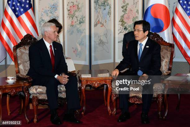 Vice President Mike Pence talks with South Korean acting president and prime minister Hwang Kyo-ahn during their meeting on April 17, 2017 in Seoul,...