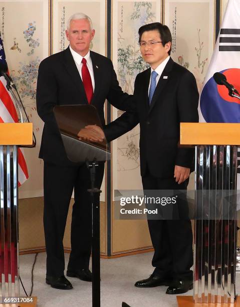 Vice President Mike Pence shakes hands with South Korean acting president and prime minister Hwang Kyo-ahn during their joint press conference on...