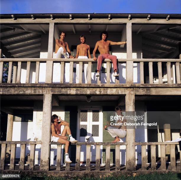 Deborah Feingold/Corbis via Getty Images) NEW YORK Musician Mark Knopfler with band Dire Straits posing in 1985 in Montserrat, British West Indies.