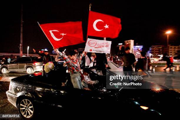 Supporters of Turkish president Recep Tayyip Erdogan celebrate the approval a constitutional referendum which would empower the president on Sunday,...