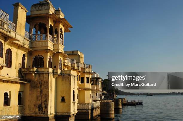 a lower portion of udaipur palace where it meets lake pichola, udaipur, rajasthan, india - haveli stock pictures, royalty-free photos & images