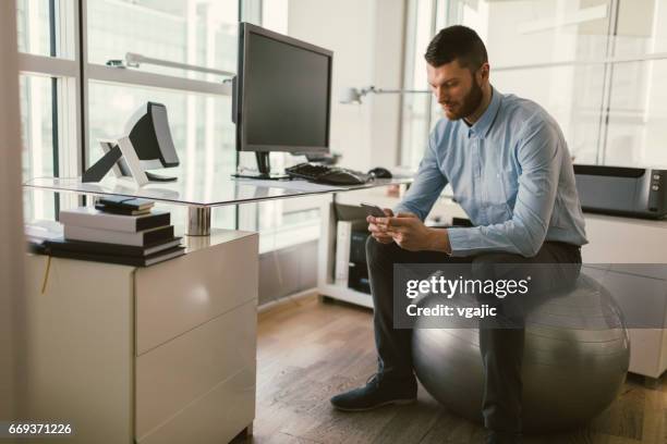 businessman working in the office - fitness ball stock pictures, royalty-free photos & images