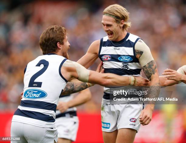 Tom Stewart of the Cats celebrates his first AFL goal with Zach Tuohy of the Cats during the 2017 AFL round 04 match between the Hawthorn Hawks and...