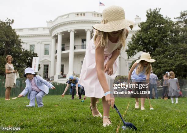 Kids participate in an Easter egg roll race during the 139th White House Easter Egg Roll on the South Lawn of the White House in Washington, DC,...