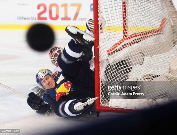Jerome Flaake of Muenchen is smashed and earns a pentalty goal during the DEL Play-Offs Final Match 5 between EHC Muenchen and the Grizzlys Wolfsburg...