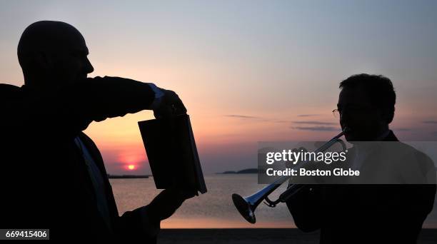 The Rev. Matthew Johnstone, left, holds the music for the Rev. Burns Stanfield, as he plays "Jesus Christ is Risen Today" on the trumpet. The...