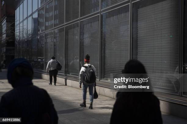 Pedestrians pass in front of Goldman Sachs Group Inc. Headquarters in New York, U.S., on Friday April 14, 2017. The Goldman Sachs Group Inc. Is...