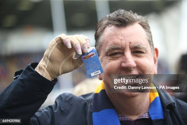 Chris King, the UK's first double hand transplant patient, holds up a Golden Gamble ticket after the Leeds Rhinos rugby league team ran onto the...
