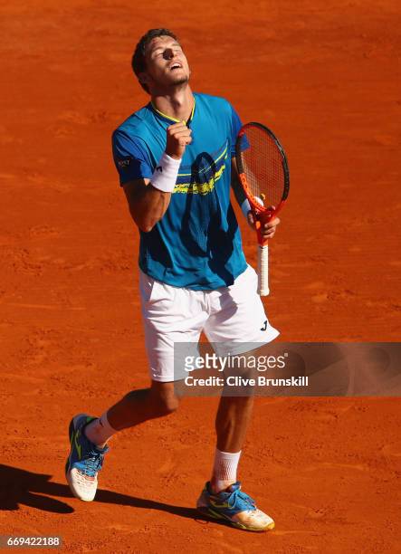 Pablo Carreno Busta of Spain celebrates match point against Fabio Fognini of Italy in their first round match on day two of the Monte Carlo Rolex...