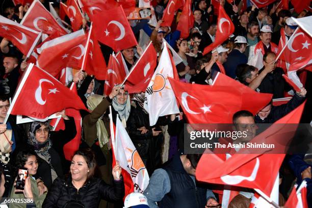 People celebrate the 'Evet' vote result outside AK Party headquarters on April 16, 2017 in Ankara, Turkey. Millions of Turks are heading to the polls...