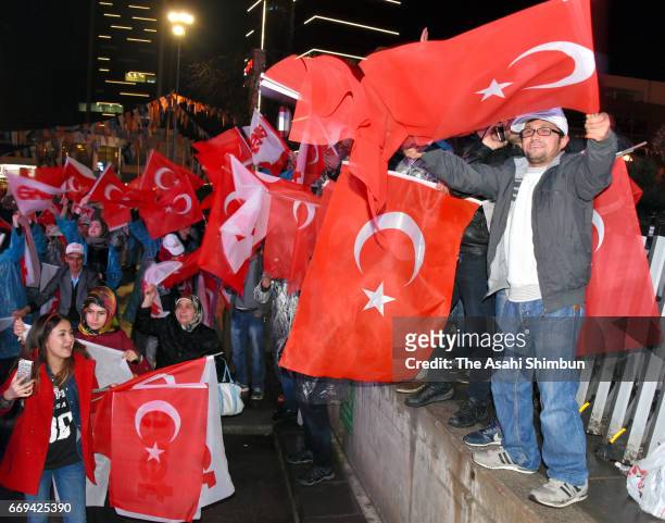 People celebrate the 'Evet' vote result outside AK Party headquarters on April 16, 2017 in Ankara, Turkey. Millions of Turks are heading to the polls...