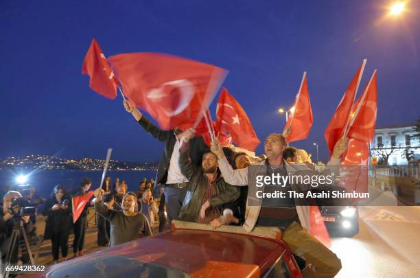 People celebrate the 'Evet' vote result outside AK Party headquarters on April 16, 2017 in Istanbul, Turkey. Millions of Turks are heading to the...