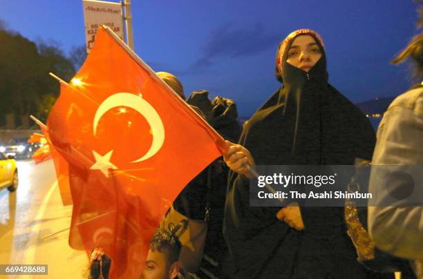 People celebrate the 'Evet' vote result on April 16, 2017 in Istanbul, Turley. Millions of Turks are heading to the polls to vote on a set of 18...