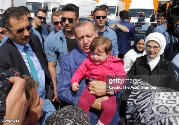 Turkish president Recep Tayyip Erdogan poses for photographs after casting his ballot for the referendum at a polling station on April 16, 2017 in...