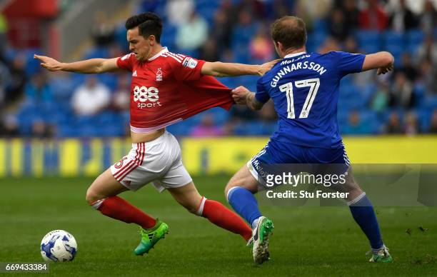 Cardiff player Aron Gunnarsson gets to grips with Zach Clough of Forest during the Sky Bet Championship match between Cardiff City and Nottingham...