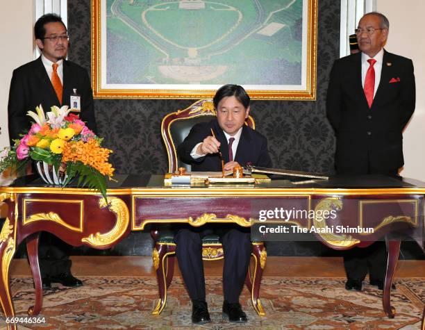 Crown Prince Naruhito of Japan signs at the Istana Negara on April 16, 2017 in Kuala Lumpur, Malaysia. Crown Prince is 5-day tour to Malaysia to mark...