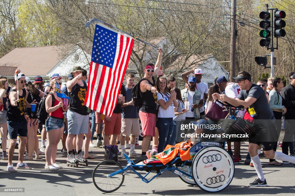 Crowds Gather Along Route Of Boston Marathon To Cheer On Runners