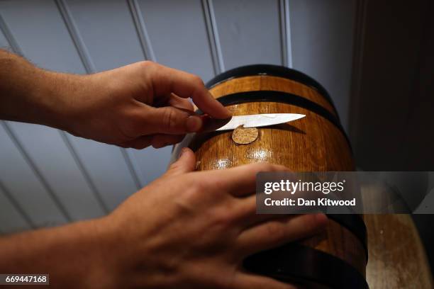 One of the bottles is readied to be sealed with a wax emblem in the shape of a hare ahead of the Hare Pie Scramble, and Bottle Kicking event on April...