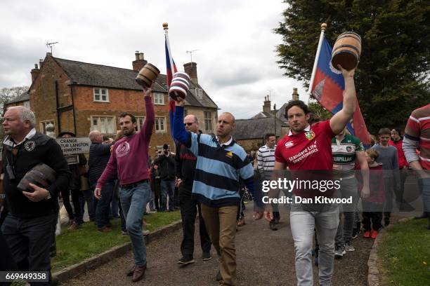 The Bottles are held aloft by members of the Hallaton team ahead of the bottle kicking on April 17, 2017 in Hallaton, England. Hallaton hosts the...