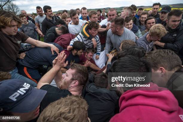 The first round of the bottle Kicking gets underway over the Hare Pie Hill on April 17, 2017 in Hallaton, England. Hallaton hosts the Hare Pie...