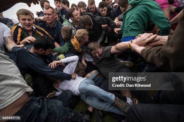 The first round of the bottle Kicking gets underway over the Hare Pie Hill on April 17, 2017 in Hallaton, England. Hallaton hosts the Hare Pie...