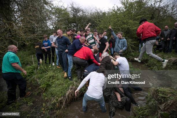 The first round of the bottle Kicking gets underway over the Hare Pie Hill on April 17, 2017 in Hallaton, England. Hallaton hosts the Hare Pie...