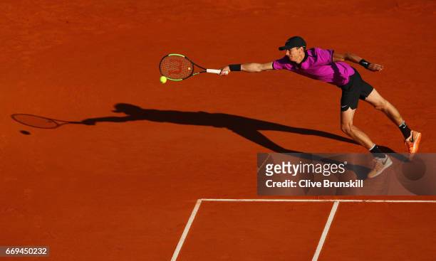 Andrey Kuznetsov of Russia stretches to play a forehand against Tomas Berdych of the Czech Republic in their first round match on day two of the...