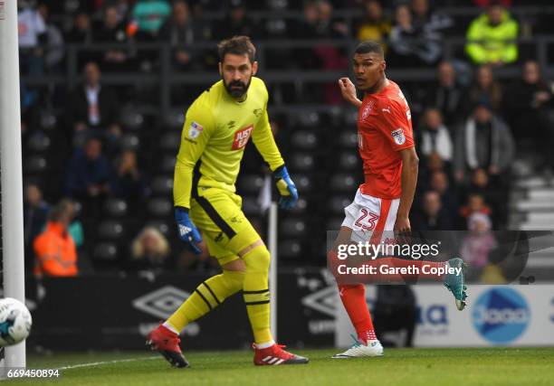 Collin Quaner of Huddersfield Town scores the opening goal past Scott Carson of Derby County during the Sky Bet Championship match between Derby...