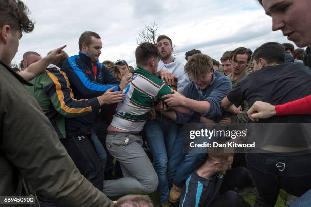 The first round of the bottle Kicking gets underway over the Hare Pie Hill on April 17, 2017 in Hallaton, England. Hallaton hosts the Hare Pie...