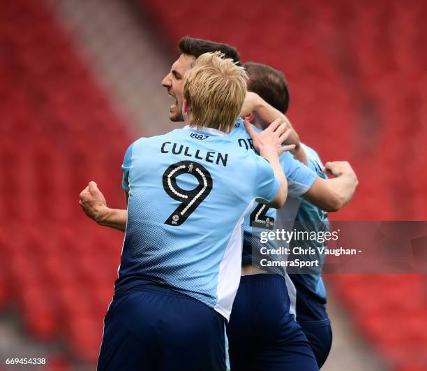 Blackpool's Jordan Flores, centre, celebrates scoring the opening goal from the penalty spot with team-mates Mark Cullen, left, and Tom Aldred during...