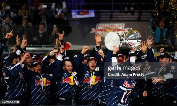 Michael Wolf of Muenchen and his team mates celebrate winning the DEL Play-Offs Final Match 5 between EHC Muenchen and the Grizzlys Wolfsburg at...