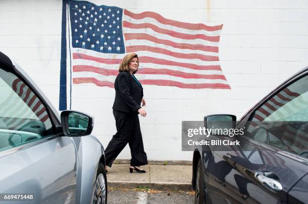 Karen Handel, candidate for the Georgia 6th Congressional district, walks past an American flag as she arrives for a campaign stop at Rhea's...