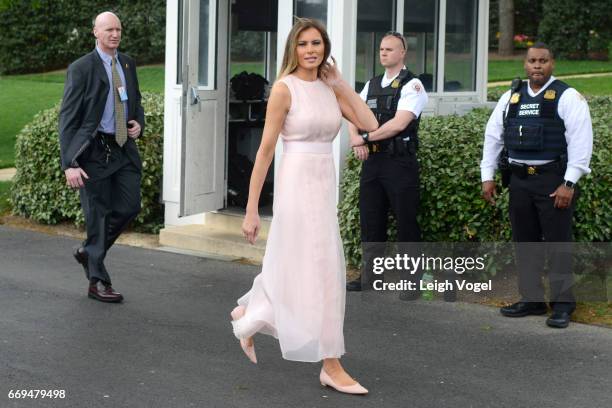 First Lady Melania Trump walks toward the Oval Office after reading to children during the 139th White House Easter Egg Roll at The White House on...