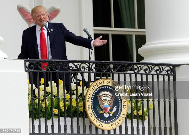 President Donald Trump delivers remarks from the Truman Balcony to guests on the South Lawn during the 139th White House Easter Egg Roll at The White...