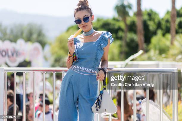 Jessica Wang eating ice cream wearing a blue jumsuiot at the Revovle Festival during day 3 of the 2017 Coachella Valley Music & Arts Festival Weekend...