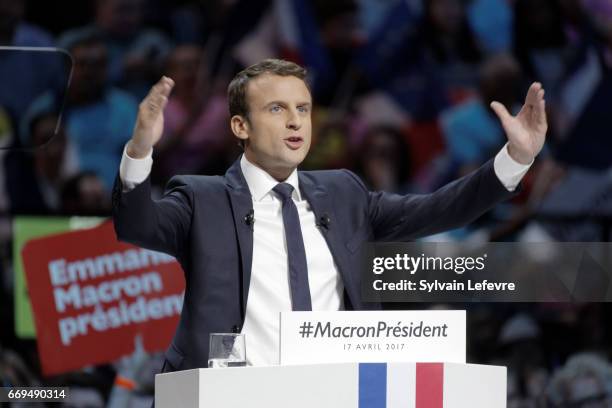 French presidential candidate Emmanuel Macron gestures as he delivers a speech during a campaign rally at Bercy Arena on April 17, 2017 in Paris,...