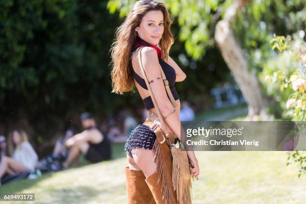Tayna Fernandes wearing a cropped top brown pants at the Revovle Festival during day 3 of the 2017 Coachella Valley Music & Arts Festival Weekend 1...
