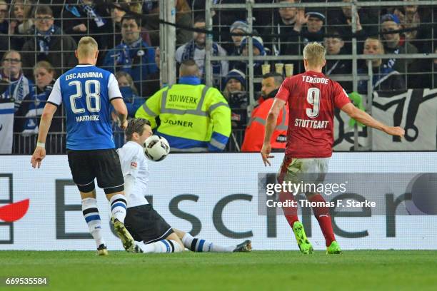 Simon Terodde of Stuttgart scores the winning goal against Daniel Davari of Bielefeld during the Second Bundesliga match between DSC Arminia...