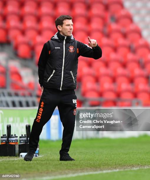 Blackpool's first team coach Richie Kyle shouts instructions to his team from the dug-out during the Sky Bet League Two match between Doncaster...
