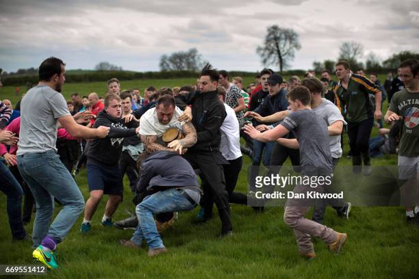 The first round of the bottle Kicking gets underway over the Hare Pie Hill on April 17, 2017 in Hallaton, England. Hallaton hosts the Hare Pie...