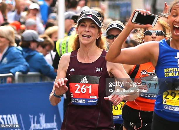 Kathrine Switzer crosses the finish line after she complete the 121st Boston Marathon on April 17, 2017.