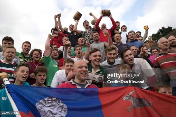 The Hallaton team celebrate after beating Medbourne in the annual Bottle Kicking over the Hare Pie Hill on April 17, 2017 in Hallaton, England....